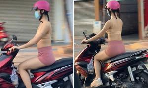Cô gái mặc bra như bán khỏa thân hồn nhiên chạy xe trên đường